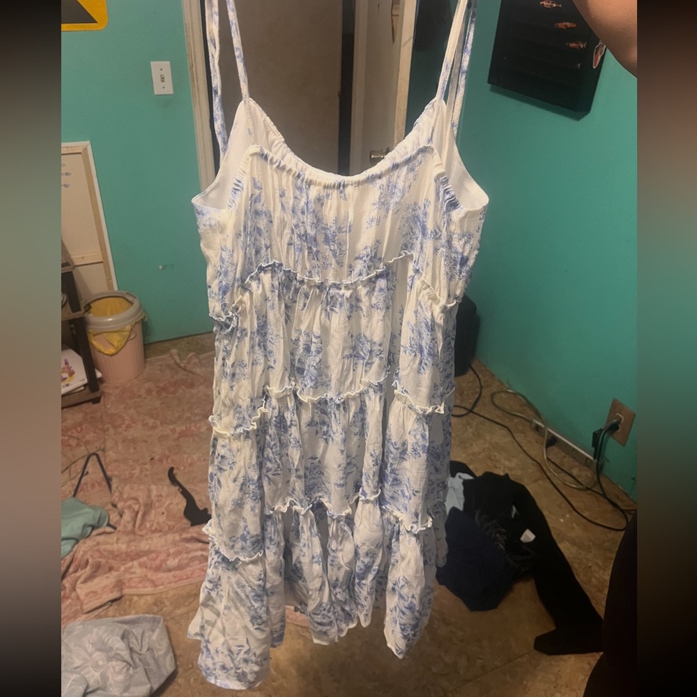 Blue and white floral summer dress. Straps tie on shoulder. Lower thigh length.